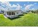 Spacious backyard with covered patio and lush green grass at 37601 Neukom Ave, Zephyrhills, FL 33541