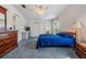 Spacious main bedroom with blue bedding and ample closet space at 37601 Neukom Ave, Zephyrhills, FL 33541