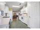 Clean kitchen with white cabinets and appliances at 37601 Neukom Ave, Zephyrhills, FL 33541