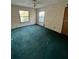 Bedroom with green carpet and two windows at 2918 6Th S Ave, St Petersburg, FL 33712