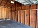 Empty garage with concrete floor, wood paneling and shelves at 3275 Fox Lake Dr, Tampa, FL 33618