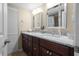 Double vanity bathroom with granite countertops and updated fixtures at 2713 4Th Ct, Palm Harbor, FL 34684