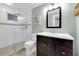 Clean bathroom with a glass shower door, white tile, and dark vanity at 130 4Th N Ave # 204-206, St Petersburg, FL 33701