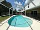 Relaxing kidney-shaped pool with screened enclosure at 5239 Tummel Ct, Wesley Chapel, FL 33545