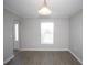 Simple dining room with wood-look flooring and a window with blinds at 5239 Tummel Ct, Wesley Chapel, FL 33545