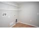 Bright laundry room with washer and dryer hookups and ample shelving at 5239 Tummel Ct, Wesley Chapel, FL 33545