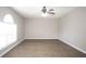 Spacious living room with wood-look flooring and a ceiling fan at 5239 Tummel Ct, Wesley Chapel, FL 33545