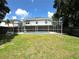 Large backyard with grassy area and fenced pool at 5239 Tummel Ct, Wesley Chapel, FL 33545