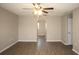 Open living room with wood-look flooring and an arched doorway at 5239 Tummel Ct, Wesley Chapel, FL 33545