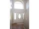 Bright entryway with tile flooring, a large window, and a white door at 5239 Tummel Ct, Wesley Chapel, FL 33545