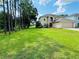 Two-story house with a spacious backyard and lush green landscaping at 5239 Tummel Ct, Wesley Chapel, FL 33545