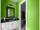 Bathroom with a green vanity, black countertop, and walk-in closet at 909 Shoals Landing Dr, Brandon, FL 33511