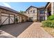Three-car garage with brick paver driveway and stone exterior at 909 Shoals Landing Dr, Brandon, FL 33511