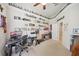 Bright home office features wall-to-wall shelving, a large desk, and a ceiling fan at 10110 Radcliffe Dr, Tampa, FL 33626