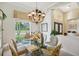 Bright dining room featuring a glass table and a large window overlooking the backyard at 10110 Radcliffe Dr, Tampa, FL 33626