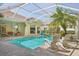 Lush pool area with screened enclosure, patio, and comfortable seating at 10110 Radcliffe Dr, Tampa, FL 33626