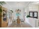 Elegant dining room with chandelier, glass table and built-in hutch at 10110 Radcliffe Dr, Tampa, FL 33626