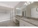 Primary bathroom with double vanity, granite countertops, and walk-in shower at 11321 Alachua Creek Ln, Riverview, FL 33579