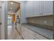 Kitchen with white cabinets, granite countertops, and view to Gathering room at 11321 Alachua Creek Ln, Riverview, FL 33579