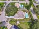 Aerial view of a home with a backyard pool, wood deck, and fenced yard at 13805 Candidate Pl, Tampa, FL 33613