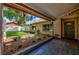 Welcoming front porch featuring tiled floors, a decorated garden bed, and an ornate front door at 13805 Candidate Pl, Tampa, FL 33613