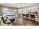 Bright living room featuring a modern kitchen, tile flooring, and sliding glass doors to the pool area at 13805 Candidate Pl, Tampa, FL 33613