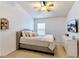 Main bedroom with large bed, TV, and ceiling fan at 26607 Chimney Spire Ln, Wesley Chapel, FL 33544