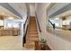 Carpeted staircase with kitchen view at 26607 Chimney Spire Ln, Wesley Chapel, FL 33544
