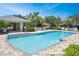 Relaxing community pool with surrounding patio and lounge chairs at 26607 Chimney Spire Ln, Wesley Chapel, FL 33544