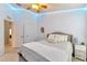 Bedroom with ceiling fan, double bed, and ample closet space at 26607 Chimney Spire Ln, Wesley Chapel, FL 33544