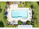 Aerial view of community pool with surrounding patio and landscaping at 26607 Chimney Spire Ln, Wesley Chapel, FL 33544