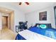 Spacious bedroom with a queen bed, workspace and access to hallway at 26607 Chimney Spire Ln, Wesley Chapel, FL 33544
