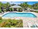 Inviting community pool with ample lounge chairs and shaded seating area at 26607 Chimney Spire Ln, Wesley Chapel, FL 33544