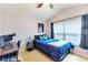 Bright bedroom with a queen bed, workspace, and large window at 26607 Chimney Spire Ln, Wesley Chapel, FL 33544