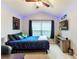 King bedroom with TV, ceiling fan, and decorative pillows at 26607 Chimney Spire Ln, Wesley Chapel, FL 33544