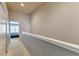 Upstairs hallway with carpet and access to bedrooms at 26607 Chimney Spire Ln, Wesley Chapel, FL 33544