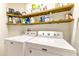 Laundry room with washer, dryer, and ample shelving at 26607 Chimney Spire Ln, Wesley Chapel, FL 33544