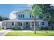 Two story home with light grey siding and a teal front door at 1007 W Baker St, Plant City, FL 33563