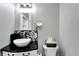 Modern bathroom with pedestal sink, black and white tile, and new fixtures at 1007 W Baker St, Plant City, FL 33563