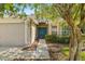 House exterior showcasing a teal front door and landscaped walkway at 9343 Rolling Circle, San Antonio, FL 33576