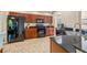 Modern kitchen with black appliances and granite countertops at 9343 Rolling Circle, San Antonio, FL 33576
