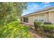 Landscaped backyard with grassy area at 9343 Rolling Circle, San Antonio, FL 33576