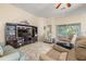 Living room featuring plush seating, a large TV, and a cozy atmosphere at 9343 Rolling Circle, San Antonio, FL 33576