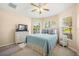 Bedroom with a queen-size bed and window with blinds at 9343 Rolling Circle, San Antonio, FL 33576