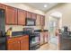 Kitchen features dark wood cabinets and granite countertops at 9343 Rolling Circle, San Antonio, FL 33576