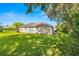 Large backyard with green grass at 9343 Rolling Circle, San Antonio, FL 33576