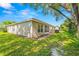 House exterior and grassy backyard at 9343 Rolling Circle, San Antonio, FL 33576