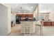 Kitchen with dark cabinetry, black appliances, and breakfast bar at 9343 Rolling Circle, San Antonio, FL 33576