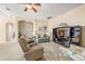 Bright living room showcasing comfortable seating and a large TV at 9343 Rolling Circle, San Antonio, FL 33576