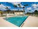 Inviting community pool with palm trees and patio area at 9343 Rolling Circle, San Antonio, FL 33576